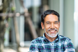 A man smiles after he attends a teeth cleaning in highway village, TX