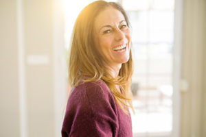 a woman smiles and laughs after learning about Splendid Dental Care in Bellaire, TX