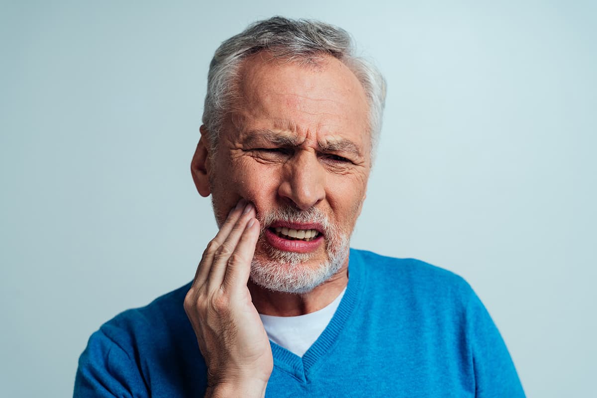 Causes of Receding Gums man deals with receding gums