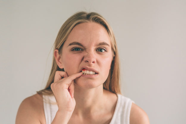 a woman checking her mouth for gum disease