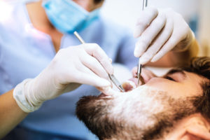 a doctor performing a tooth extraction