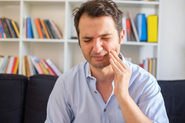a man showing symptoms of gingivitis