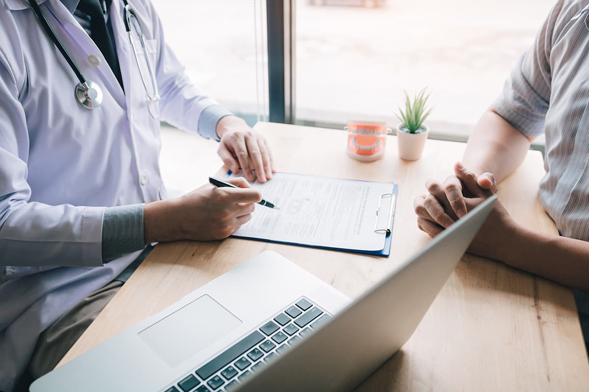 a doctor explaining how to finance dental implants