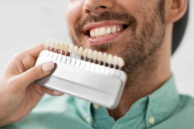 dental-veneers a dentist compares dental veneers as part of specialty dentistry services and cosmetic dentistry services