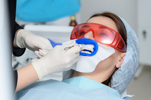 woman gets teeth whitening treatment 